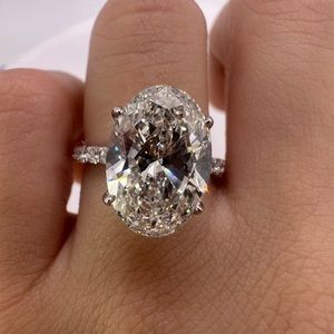 5.05 carat G VS2 oval diamond engagement ring pavé band hidden halo collar